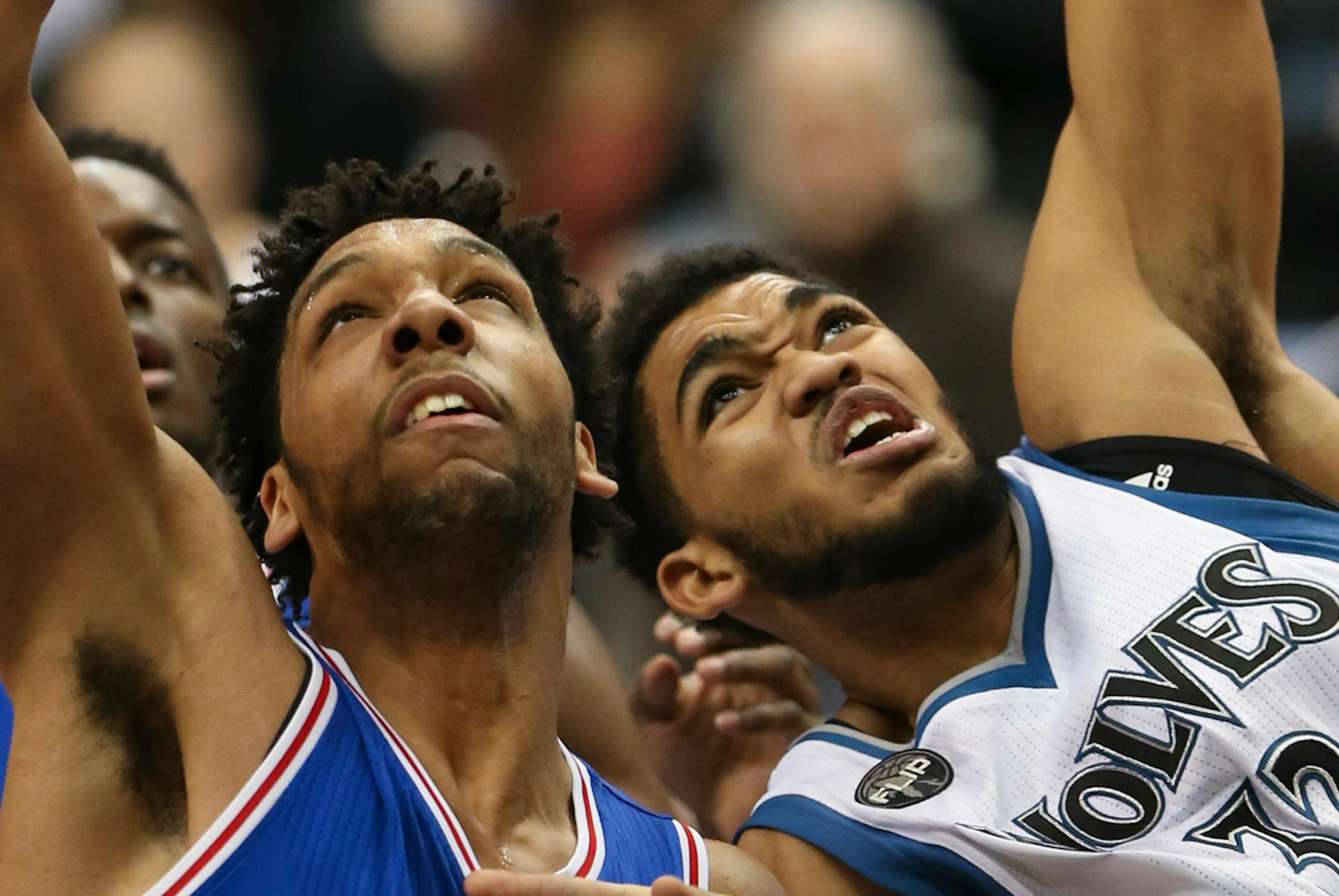 Timberwolves center Karl-Anthony Towns (32) fouled Philadelphia 76ers center Jahlil Okafor (8) as they were going for a rebound under the Wolves' net.