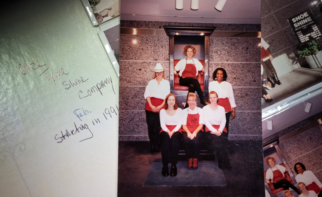 A photo of Lisa Cotton, along with the Olde Tyme Shine Company workers, when she started in the shoeshine business in 1991.