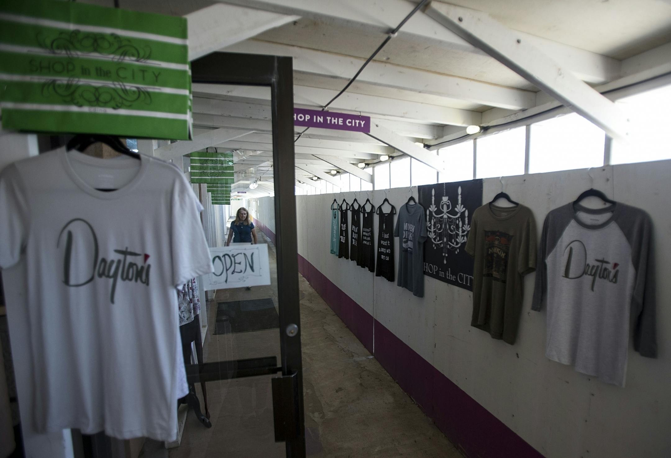Shop In The City, a small family run boutique, has hanged clothing on the boardwalk walls to try and draw in more customers.
