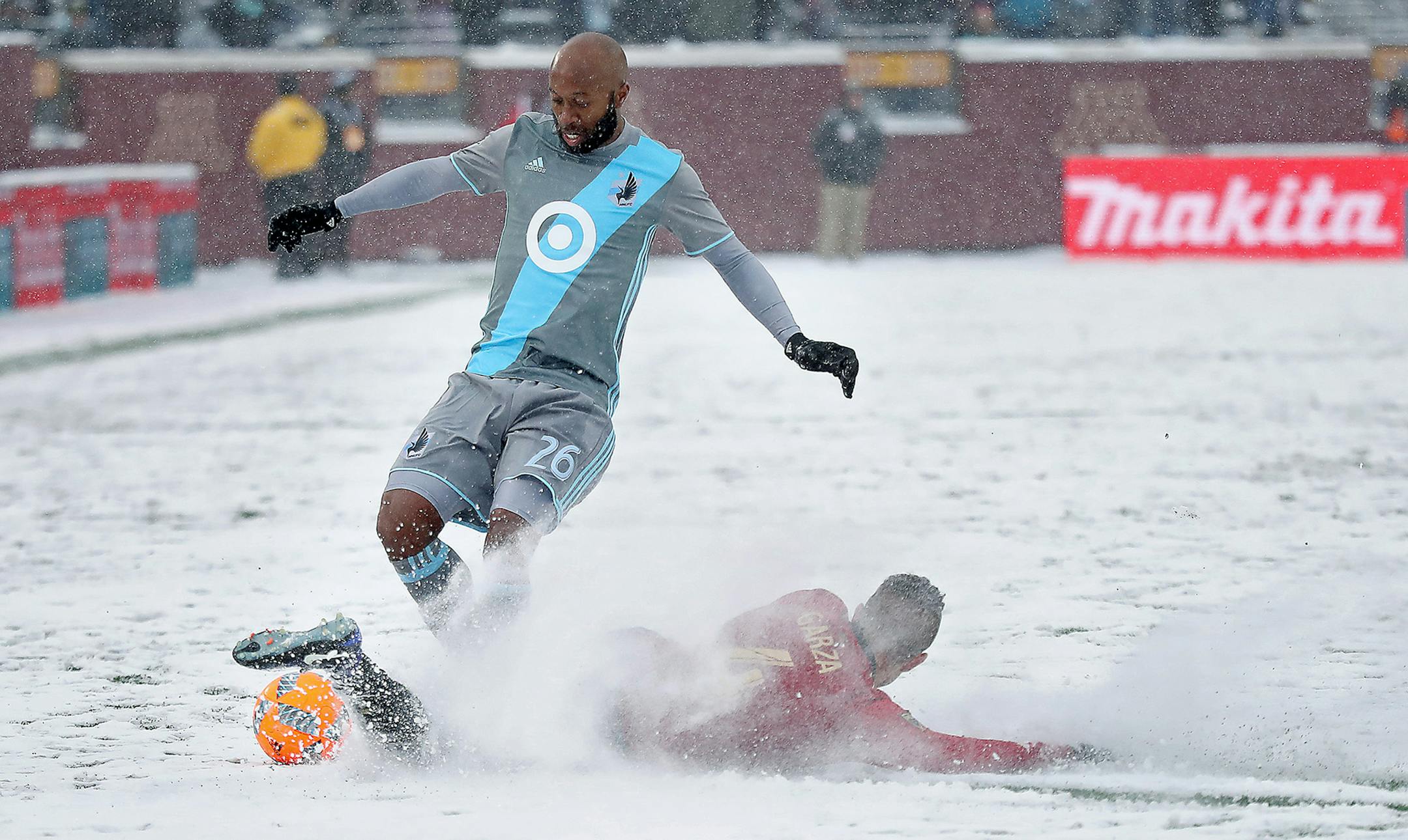 Minnesota United midfielder Collen Warner and Atlanta United defender Greg Garza battled for the ball during the second half Sunday TCF Bank Stadium.