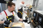 Taco John's corporate chef makes a pulled pork carnitas quesadilla at the company's new restaurant support center and test kitchen Wednesday, Nov. 9, 