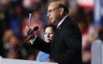 Khizr Khan, father of fallen US Army Capt. Humayun S. M. Khan, holds up his copy the United States Constitution, while his wife Ghazala Khan looks on,