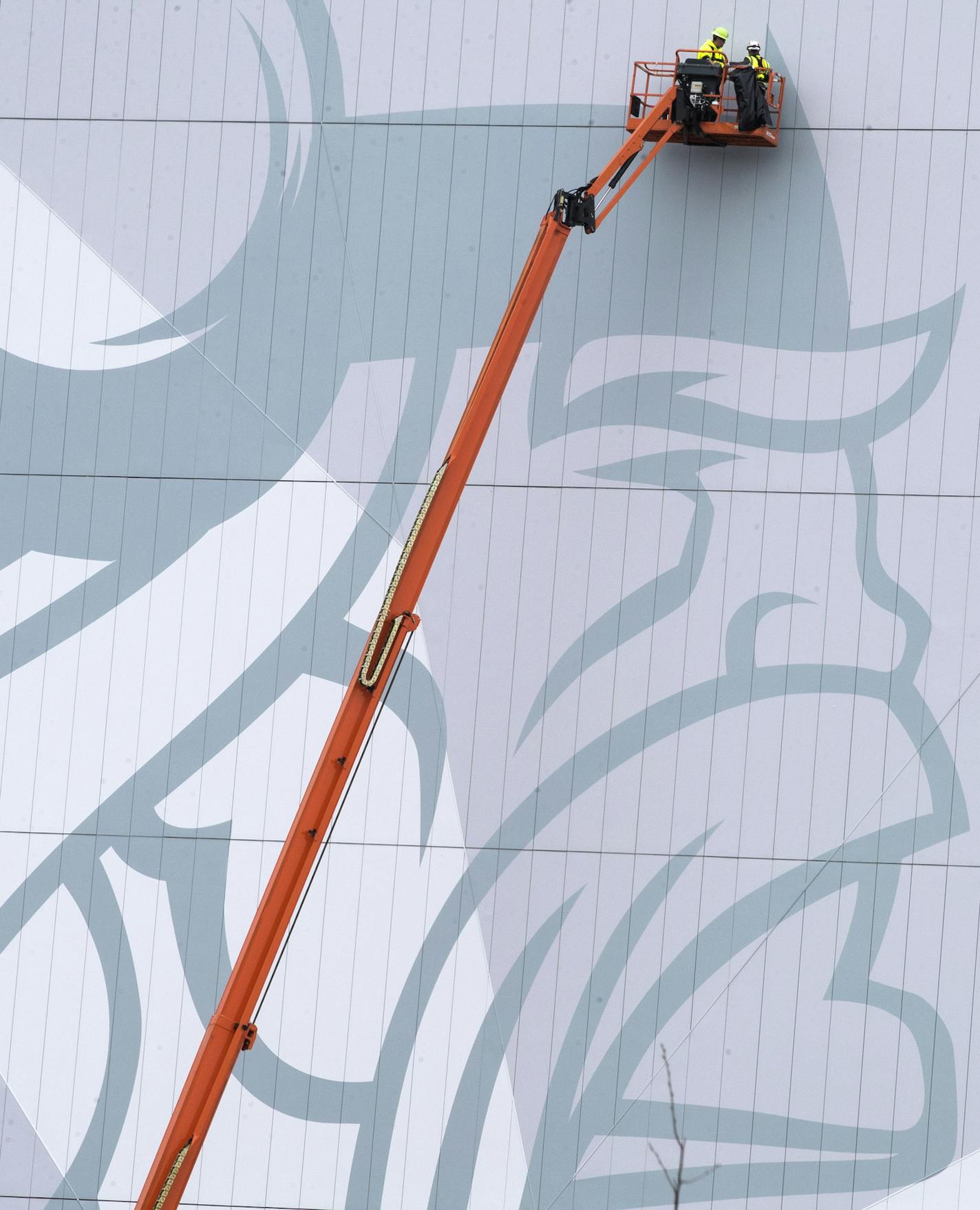 The Norseman logo is seen on the outside of the indoor arena as construction workers work on the exterior. ] LEILA NAVIDI &#xef; leila.navidi@startribune.com BACKGROUND INFORMATION: Media tour of the new Vikings facility the Twin Cities Orthopedics Performance Center in Eagan on Monday, October 23, 2017.