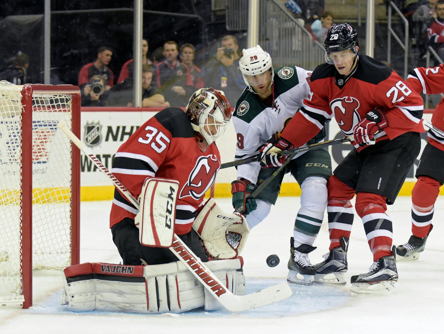 Devils goaltender Cory Schneider made a save as defenseman Damon Severson checked Wild right winger Jason Pominville during the first period Saturday.