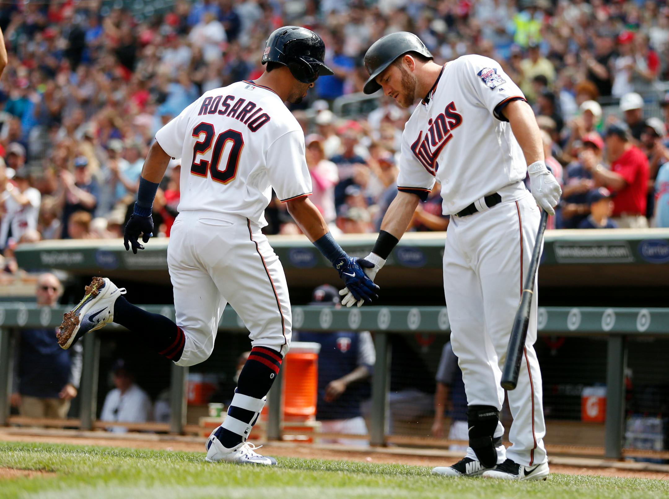 The Twins' Eddie Rosario (20) celebrated with Robbie Grossman after hitting a home run against the Rangers in the third inning Sunday.