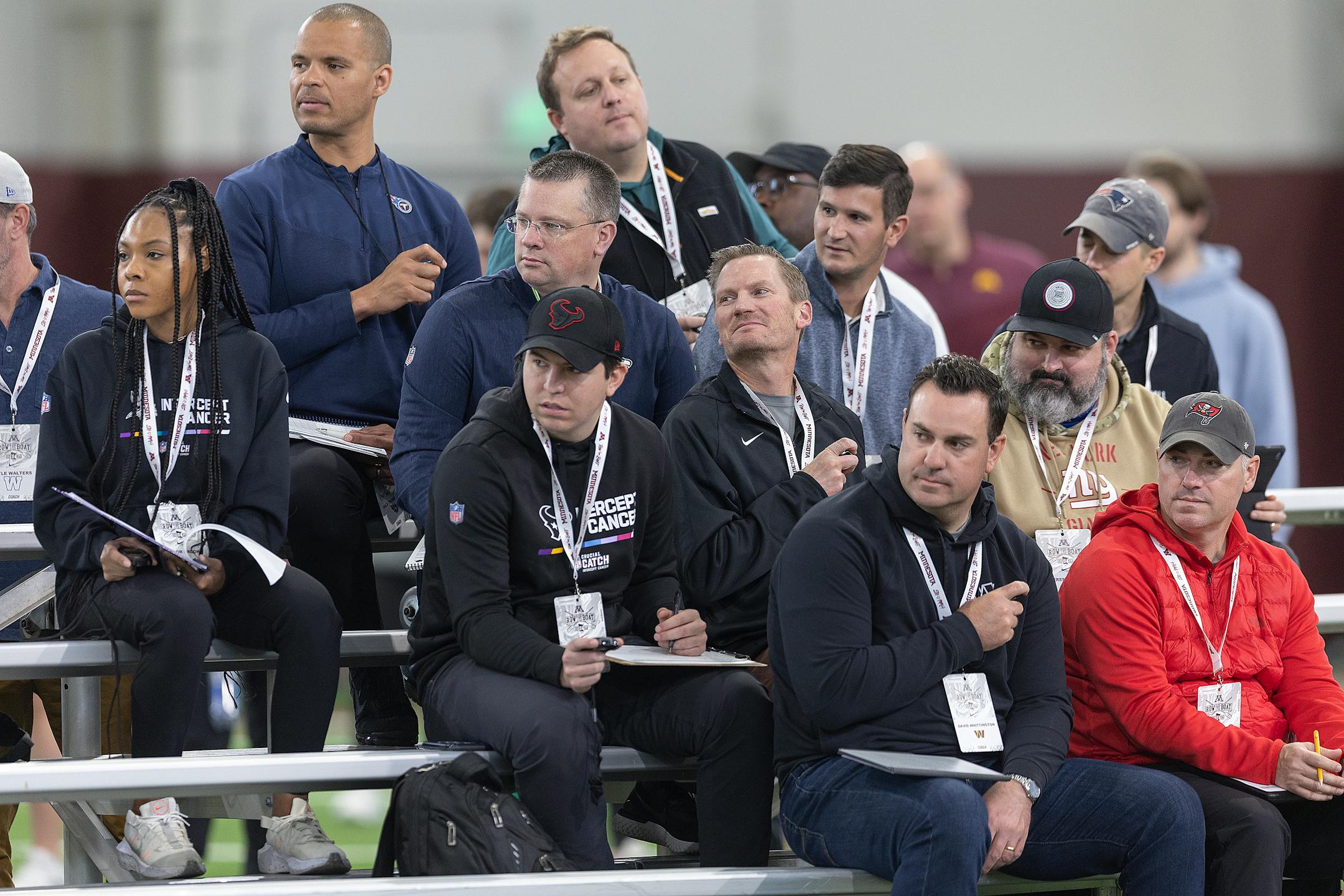 NFL football scouts time players as they run the 40-yard dash during the Minnesota Pro Day.