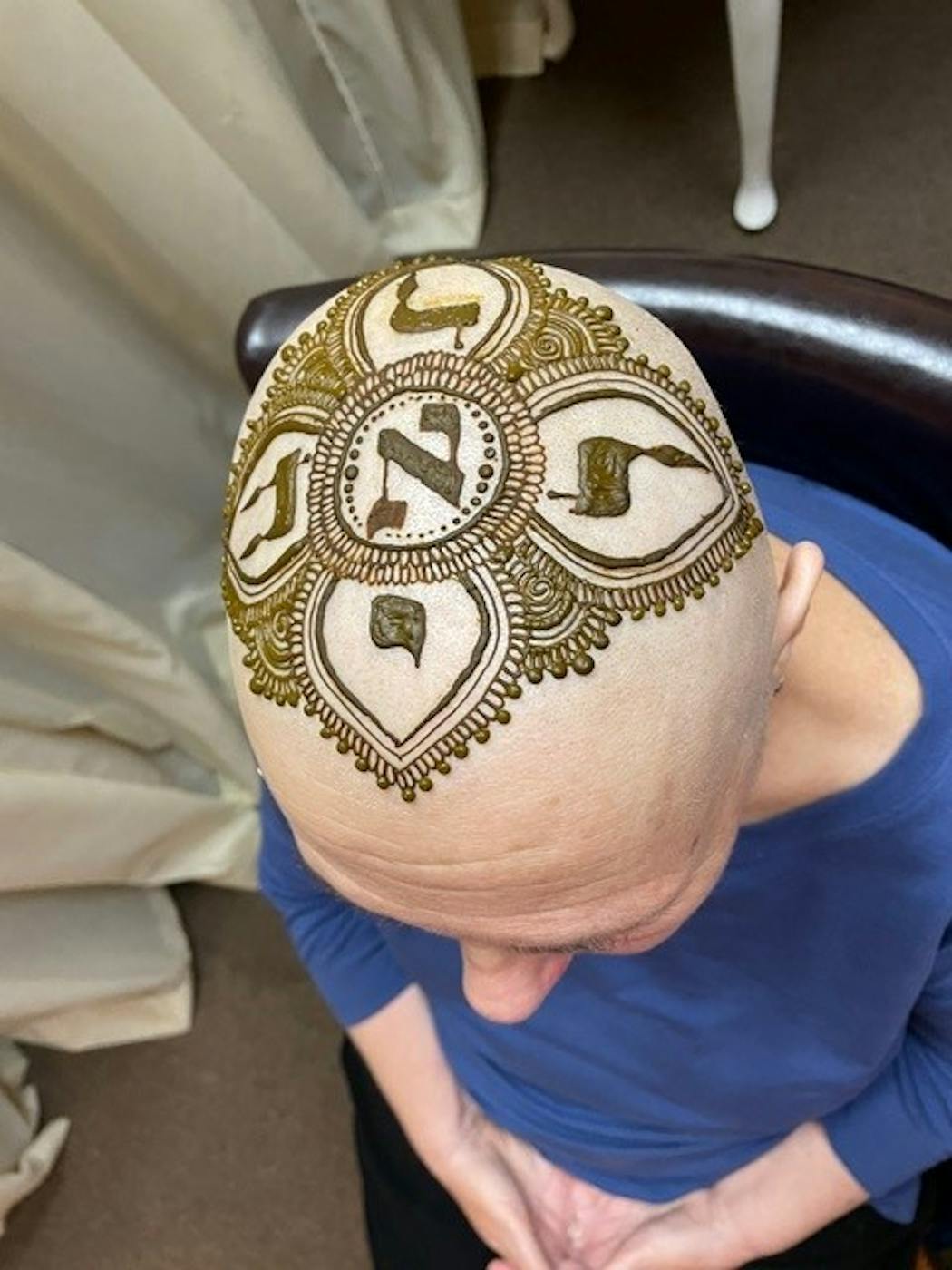Lora DeVore had Hebrew letters painted on her head by henna artist Victoria Welch.