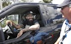 Minnesota Twins pitcher Sergio Romo stops to say goodbye to parking operations worker Bill Fear, as he drives out of Hammond Stadium, Saturday, March 