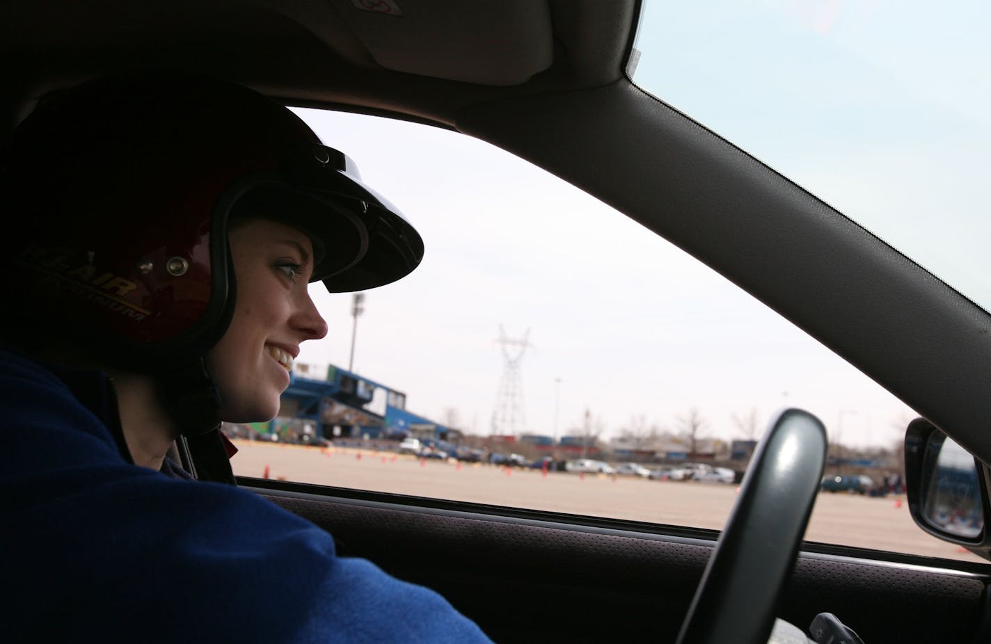 Nikki Dahlman on the track at Midway Stadium April 27. She smiles and sticks her tongue out on hard curves.