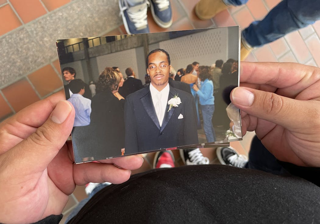 Edson Rosales held a stack of old photos from his years growing up with Antonio Moore. Here Moore is shown on prom day at Hopkins High School.