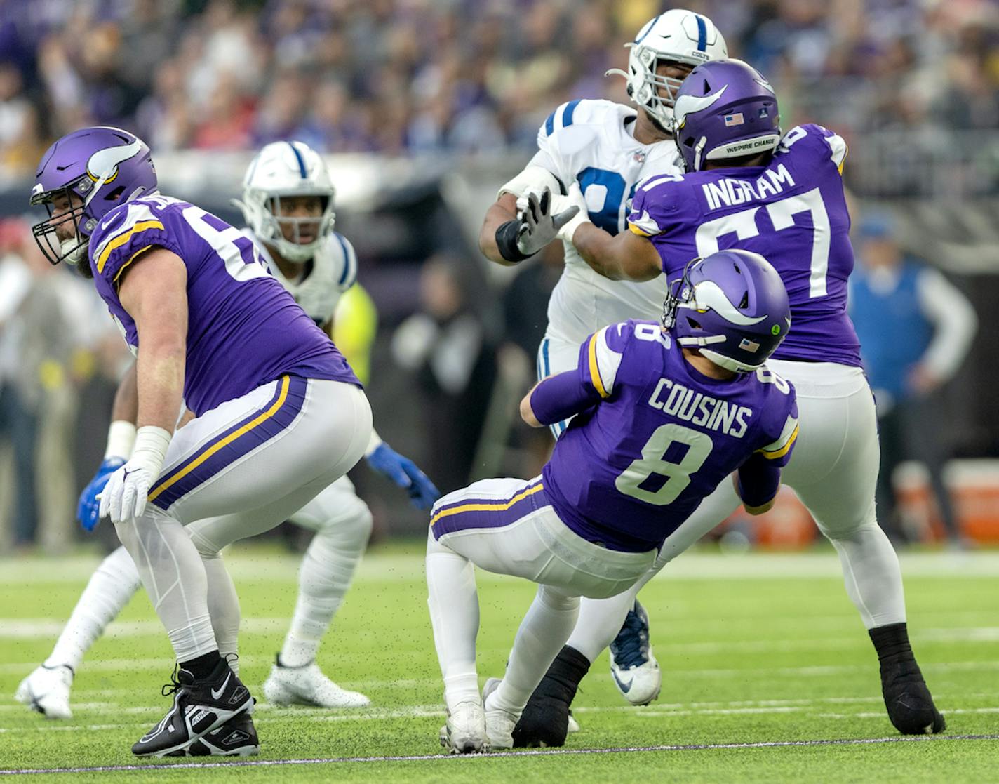 Minnesota Vikings quarterback Kirk Cousins (8) is tripped up by Ed Ingram during a game in December.