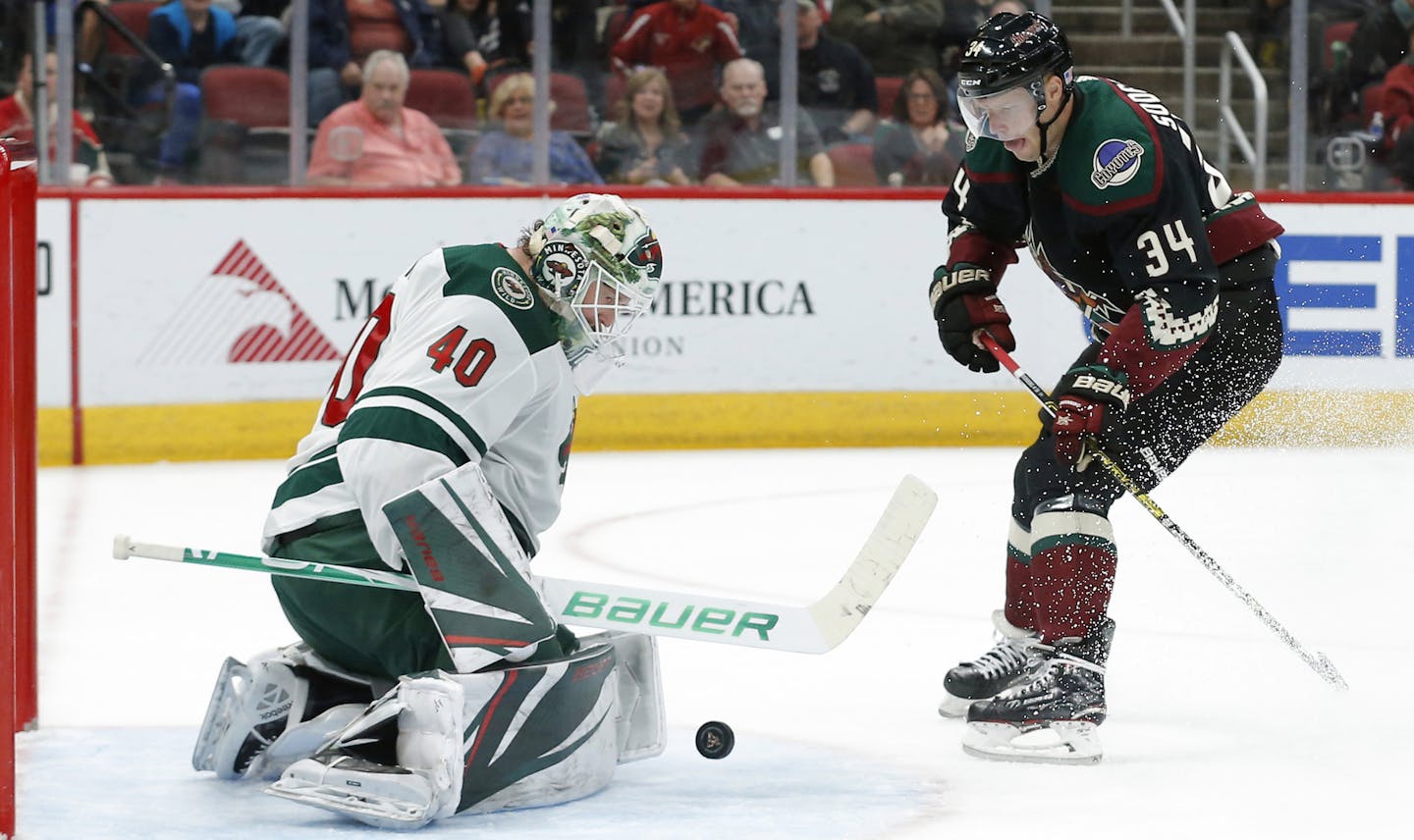 Minnesota Wild goaltender Devan Dubnyk (40) makes the save against Arizona Coyotes center Carl Soderberg in the second period during an NHL hockey game, Saturday, Nov. 9, 2019, in Glendale, Ariz. (AP Photo/Rick Scuteri)