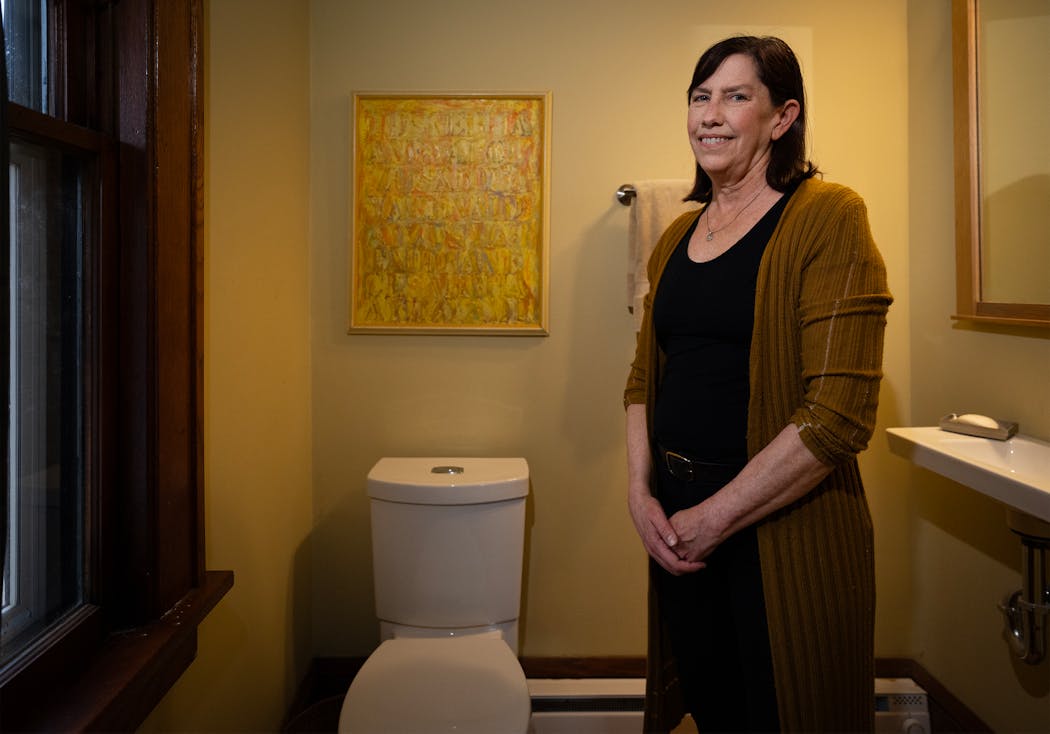 Suzy Ahrens in a bathroom converted from a sewing room.