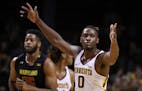 Minnesota Golden Gophers guard Akeem Springs (0) reacts after dunking the ball during the first half. ] ANTHONY SOUFFLE &#x2022; anthony.souffle@start