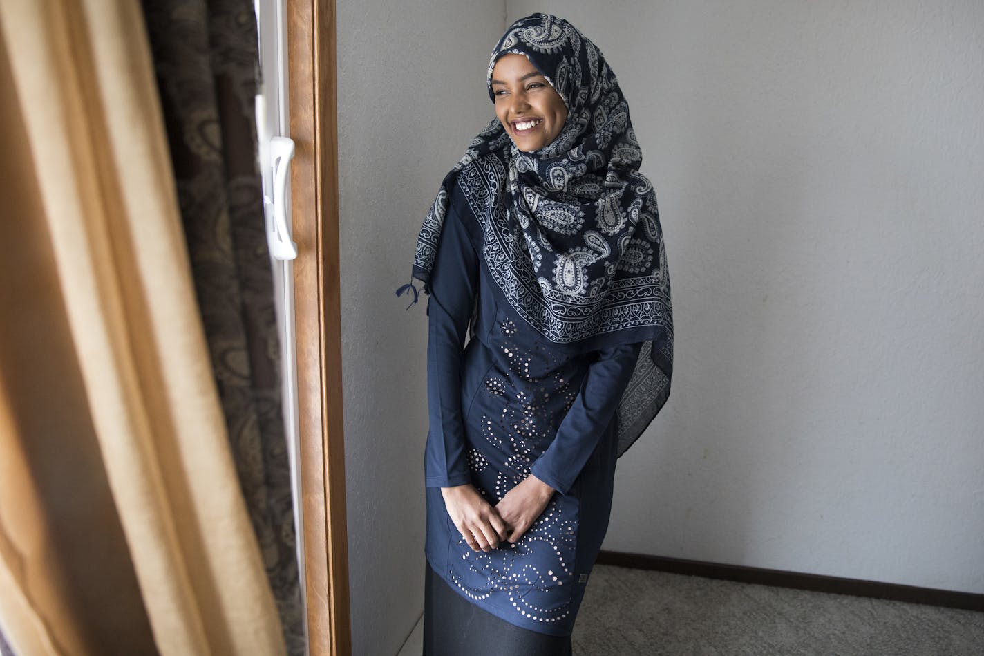 Halima Aden tried on at home the burkini she will wear for the Miss Minnesota pageant. At her mother&#x2019;s request, she added a long skirt to cover the pants of the burkini, which her mother thought immodest.