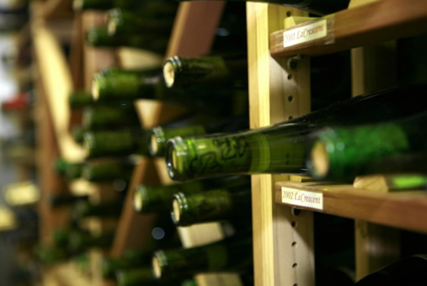 Wines from the 2002 La Crescent grape ages on the shelves in the cooler at UM's enology center.