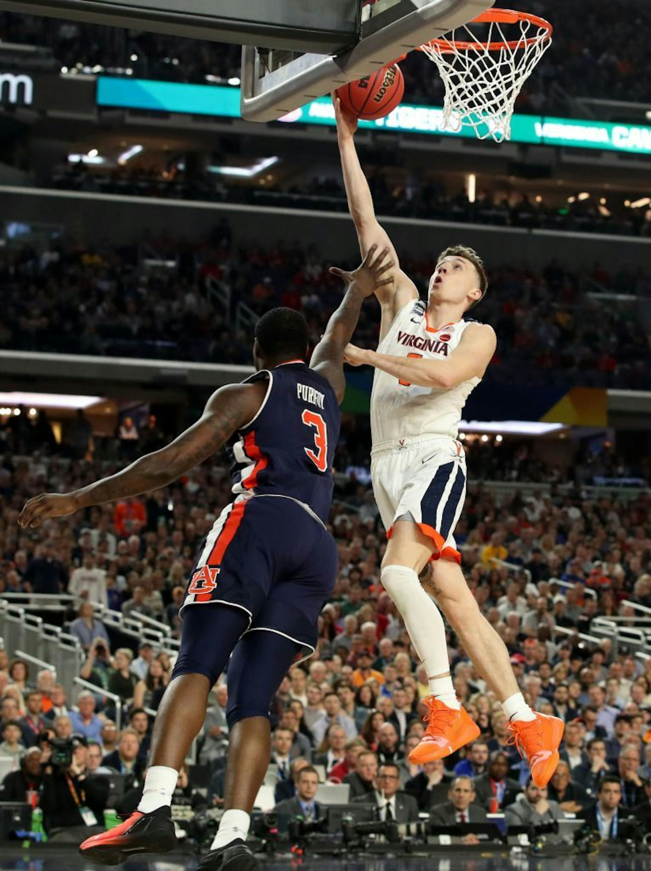 Virginia Cavaliers guard Kyle Guy (5) scored against Auburn forward Danjel Purifoy (3) during the first half.