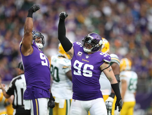 Former Vikings defensive end Brian Robison (96) celebrated with Everson Griffen, who doesn't believe Robison's NFL career is over after 11 seasons.
