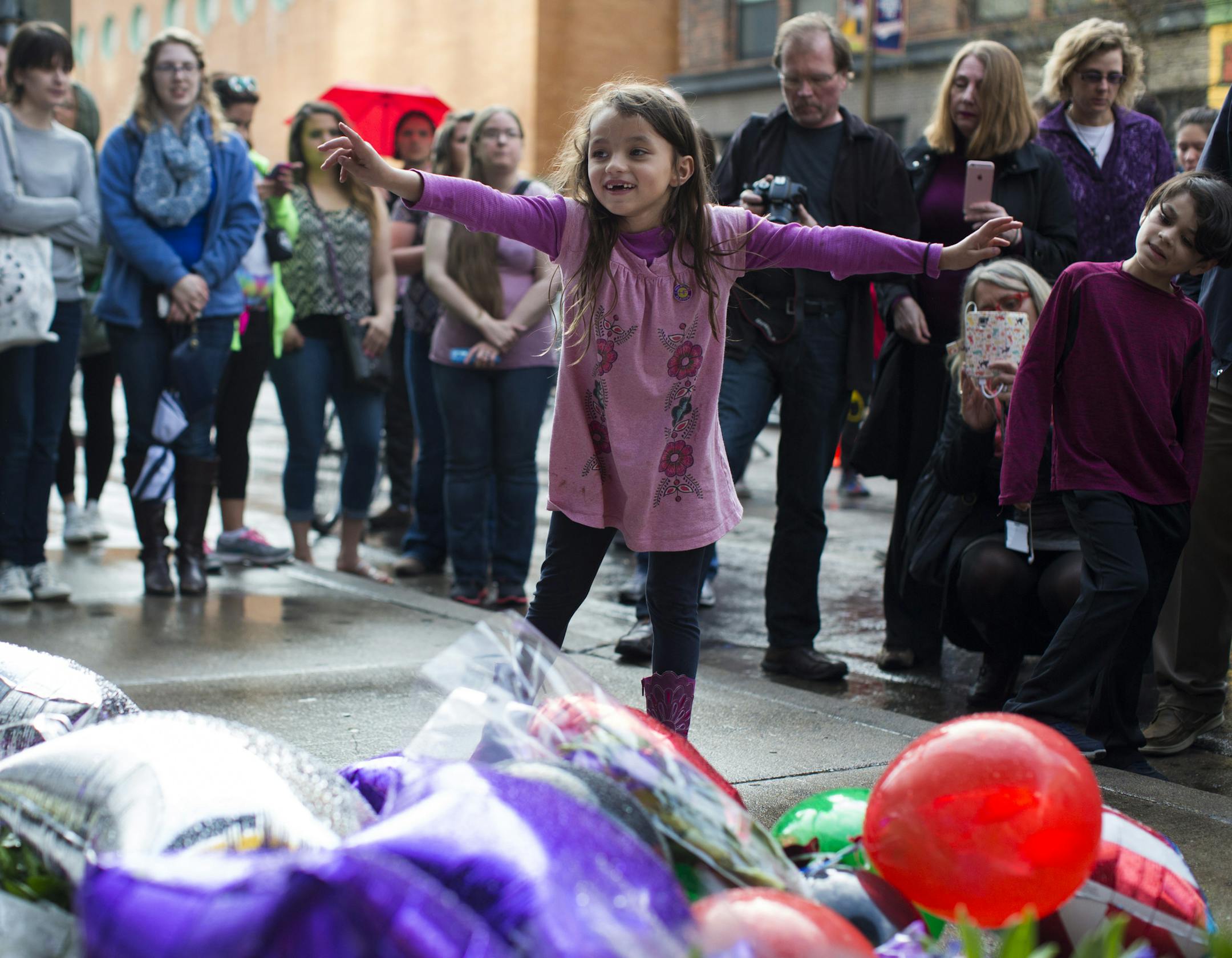 After spending the day dancing to Prince music, seven-year-old Graciella Victoria was in awe of all the flowers as she visited a memrial with her family at Prince's star at First Avenue on Thursday, April 21, 2016. Prince was found dead at his home today at the age of 57. ] RENEE JONES SCHNEIDER * reneejones@startribune.com