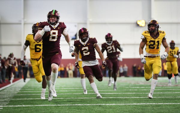 Gopher maroon linebacker Thomas Rush (8) ran 71 yards for a touchdown after an interception in the second quarter.