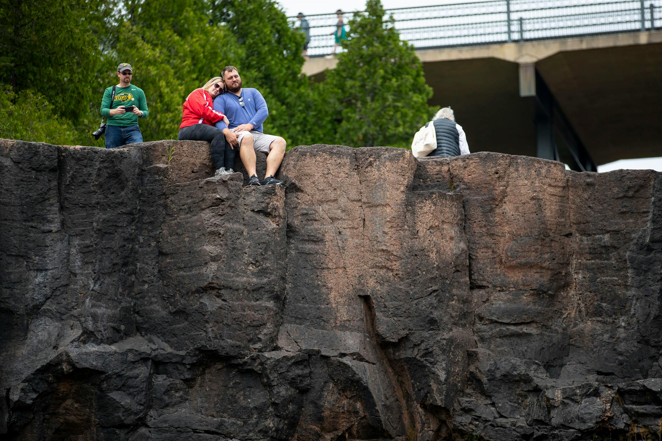 A couple sat on the top of the dried up western falls at Gooseberry Falls State Park on Wednesday, July 21, 2021. Sections of the falls have dried out because of the drought that has plagued the Midwest this summer.