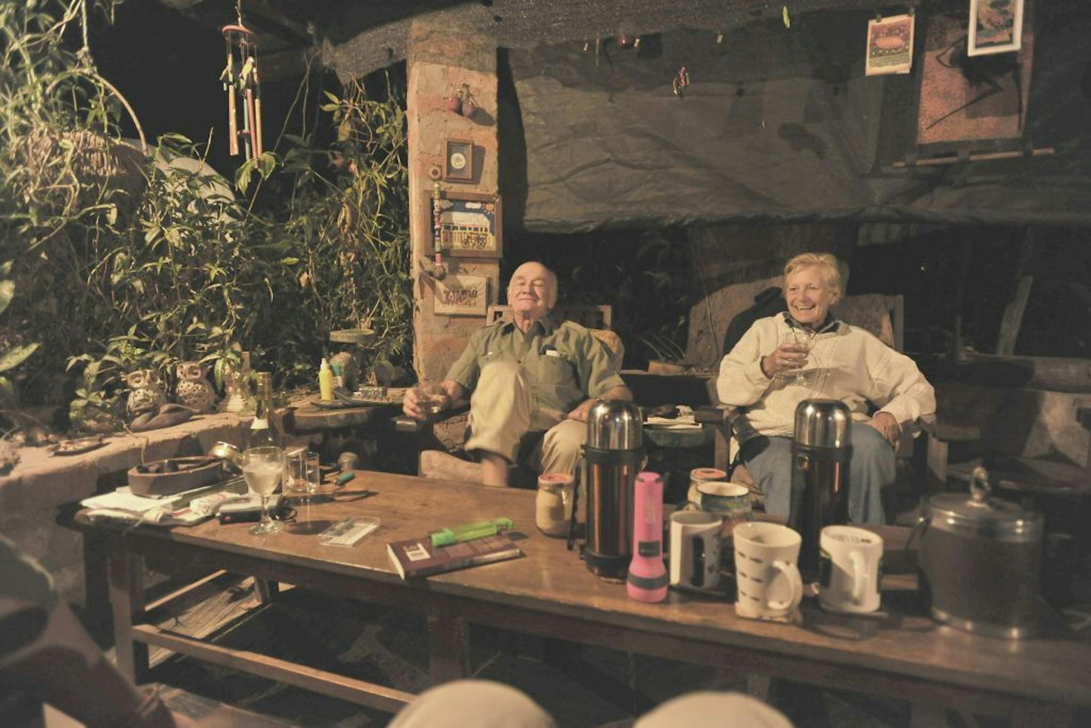 The author's father and mother (Tim and Nicola Fuller) having cocktail hour under the Tree of Forgiveness in Zambia, 2010