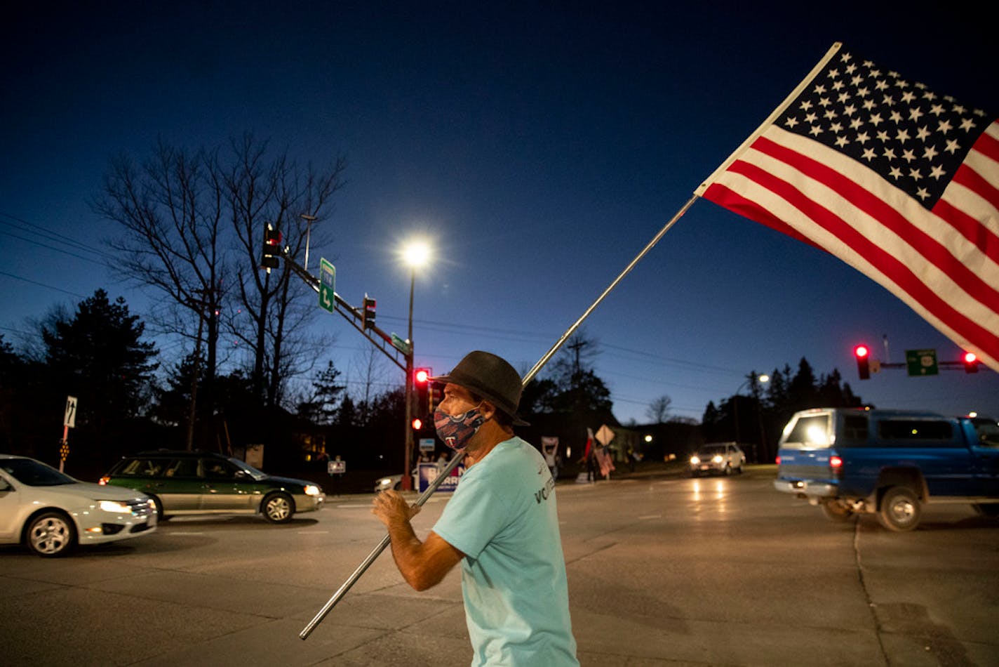 Tim Nesgoda waved a U.S. flag with a group of around 35 Joe Biden supporters who gathered in Duluth on Tuesday evening.