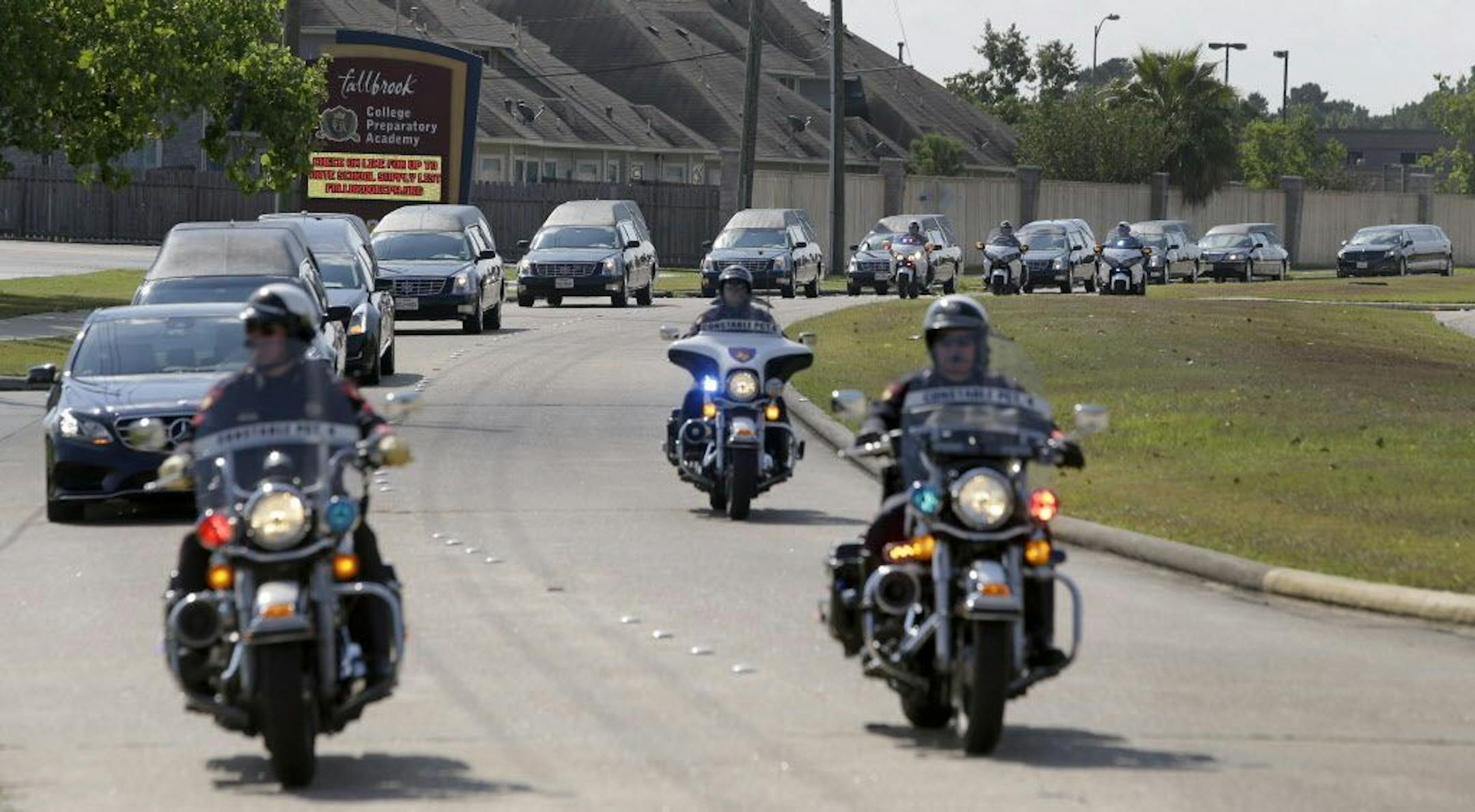 Hearses arrive for a memorial service at Fallbrook Church, Monday, Aug. 17, 2015, in Houston for a couple and six children killed in an Aug. 8 mass shooting in northwest Harris County.