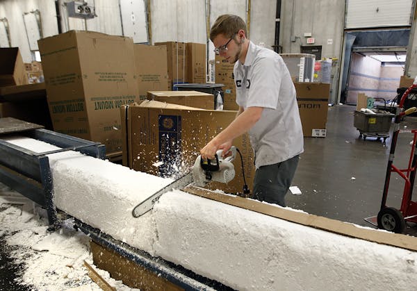 Elliot Oman, used a chainsaw to cut styrofoam at the Werners Stellian warehouse recycling department, Tuesday, May 27, 2014 in St. Paul, MN. The appli