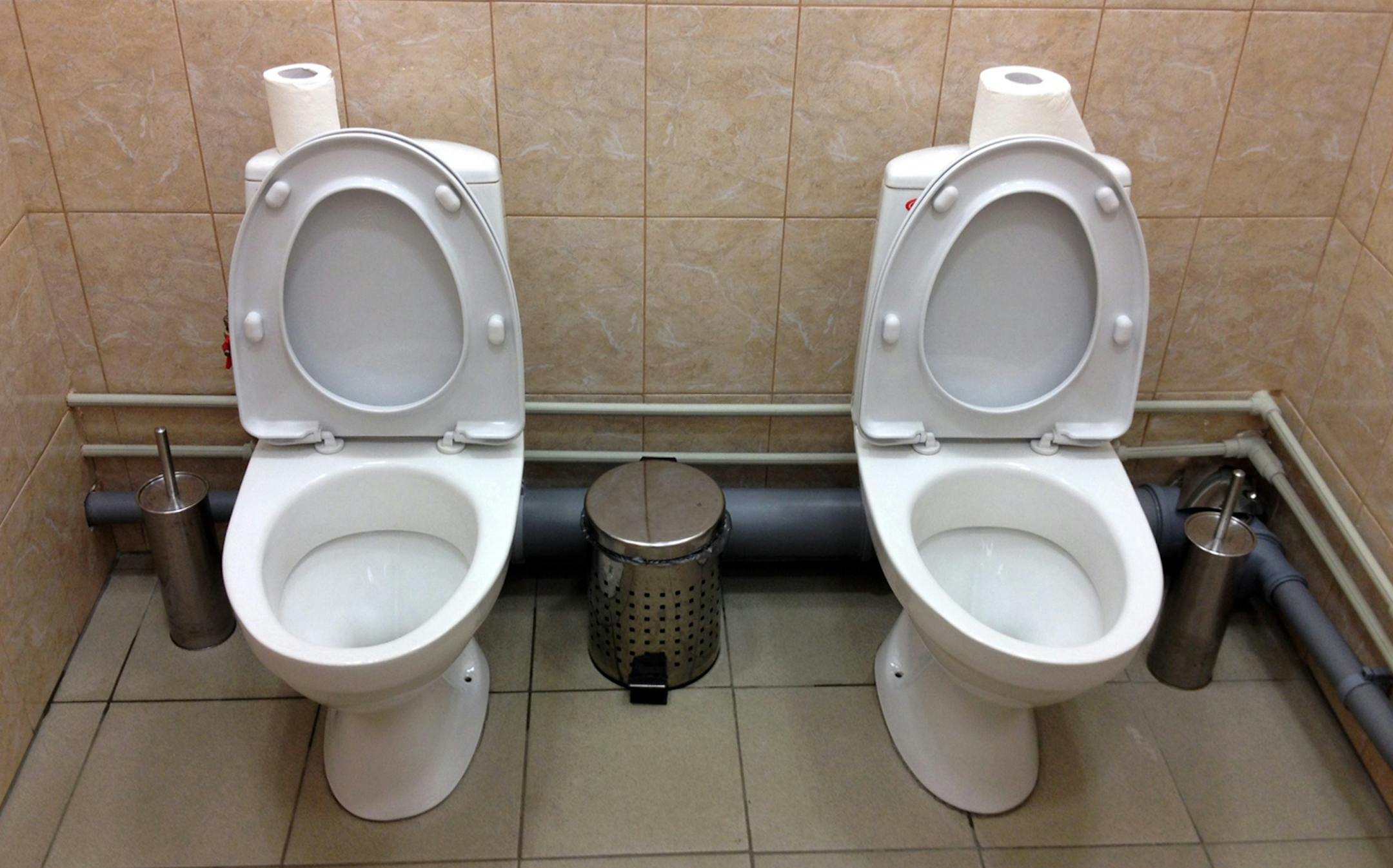 In this photo taken Saturday, Feb. 1, 2014, two female toilets sit side-by-side at the security screening facility outside the Main Press Center at the 2014 Winter Olympics, in Sochi, Russia. Side-by-side toilets in a single bathroom caused a social media sensation last month when they were discovered at the biathlon course of the Sochi Olympics, swiftly becoming a national joke in Russia. The Sochi organizing committee initially denied knowledge of the second twin toilet, and it has not been ab