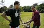 Amir Coffey and his father Richard Coffey joked around while playing golf at the Theodore Wirth Par 3 golf course in Golden Valley. ] CARLOS GONZALEZ 