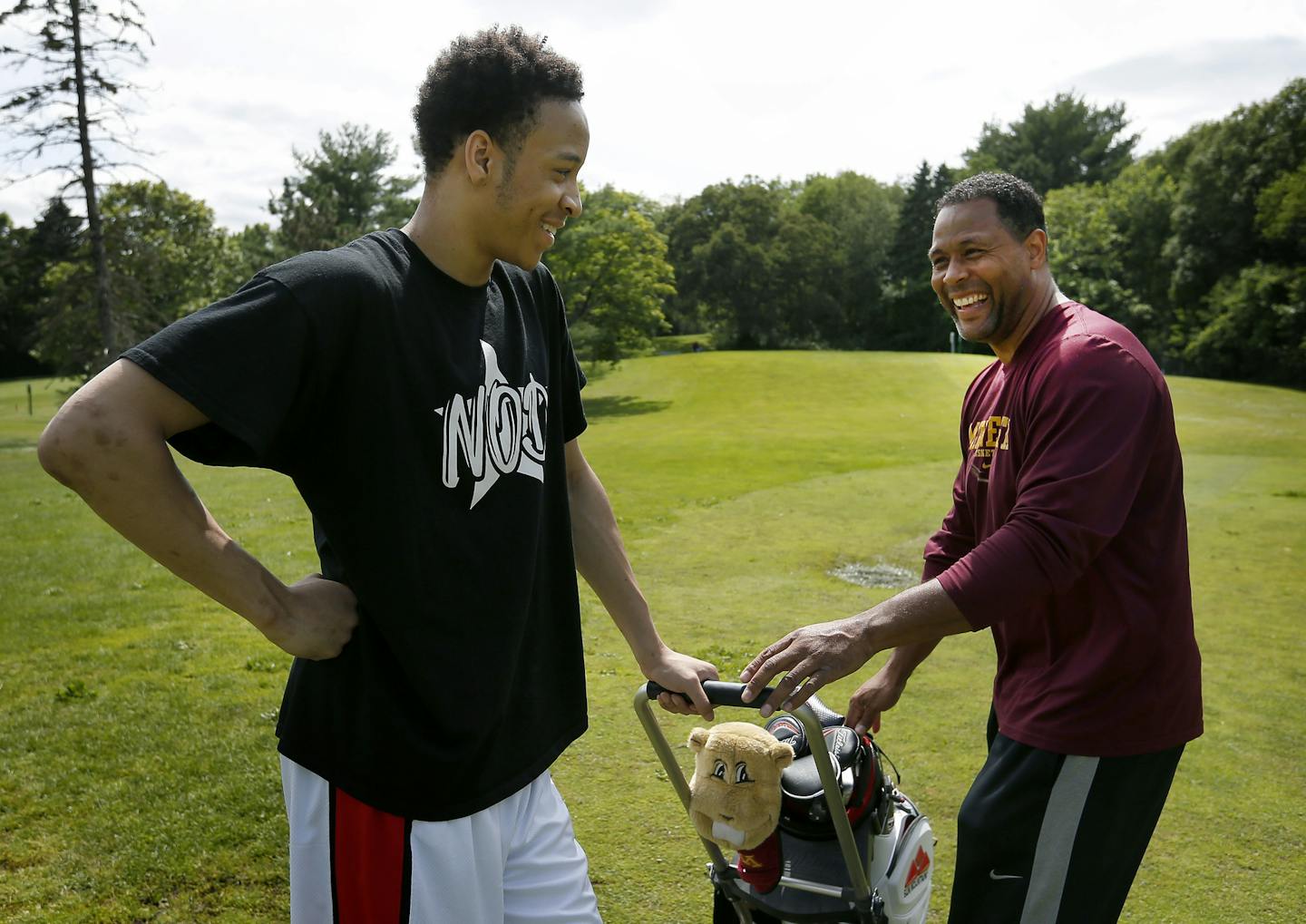 Amir Coffey and his father Richard Coffey joked around while playing golf at the Theodore Wirth Par 3 golf course in Golden Valley. ] CARLOS GONZALEZ cgonzalez@startribune.com - July 7, 2015, Golden Valley, MN, Hopkins senior-to-be Amir Coffey and father Richard Coffey playing golf at the Theodore Wirth Par 3 golf course.