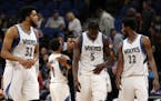 Minnesota Timberwolves players including center Karl-Anthony Towns (32), forward Gorgui Dieng (5), and forward Andrew Wiggins (22) leave the court aft