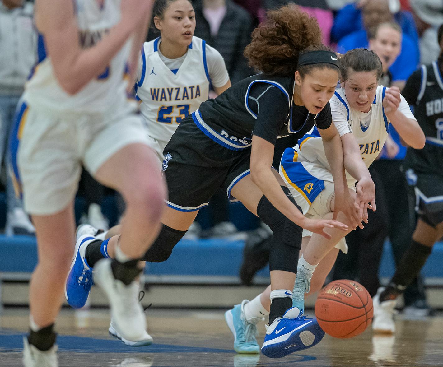 Hopkins' Amaya Battle and Wayzata's Alivia Arnebeck battled for the ball during the first half of their match up in the Class 4A, Section 6 girls' basketball championship at the Lindbergh Center, Thursday, March 5, 2020 in Hopkins, MN. ] ELIZABETH FLORES • liz.flores@startribune.com