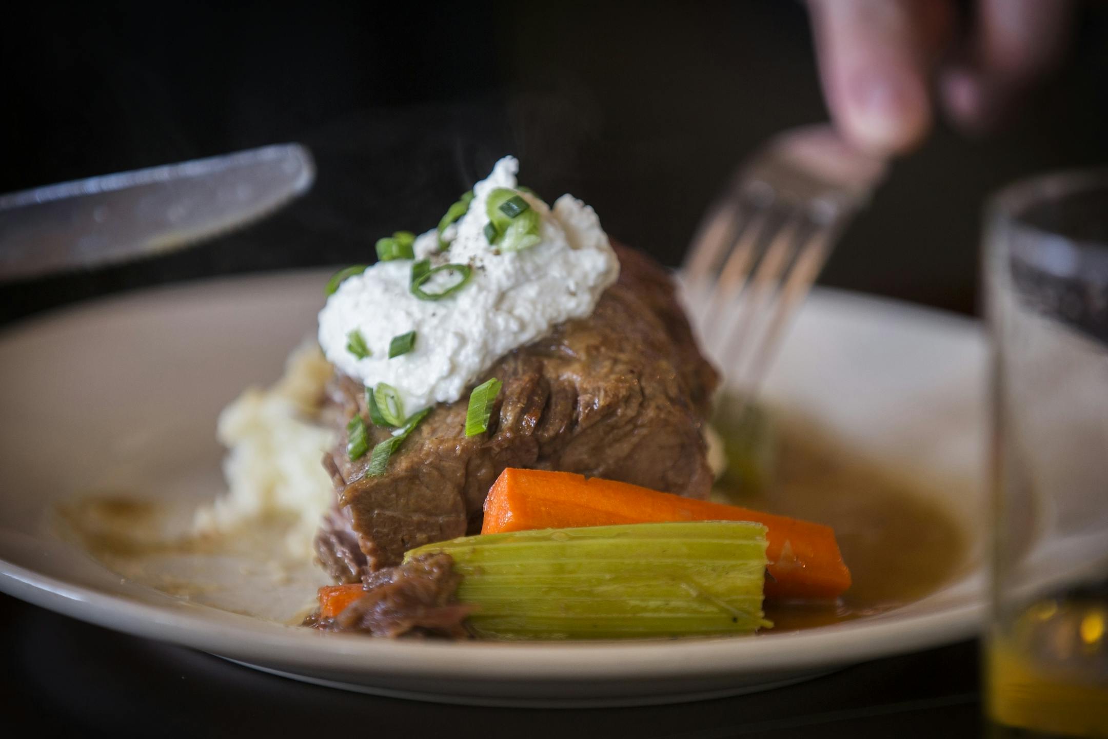 A customer digs into the famous pot roast at the Modern Cafe in Minneapolis on Tuesday, March 10, 2015.