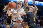 Becker's Alexis Rose, left, and Mankato East's Macy Birkholz battle for the ball during the first half of their match up at Williams Arena in Minneapo
