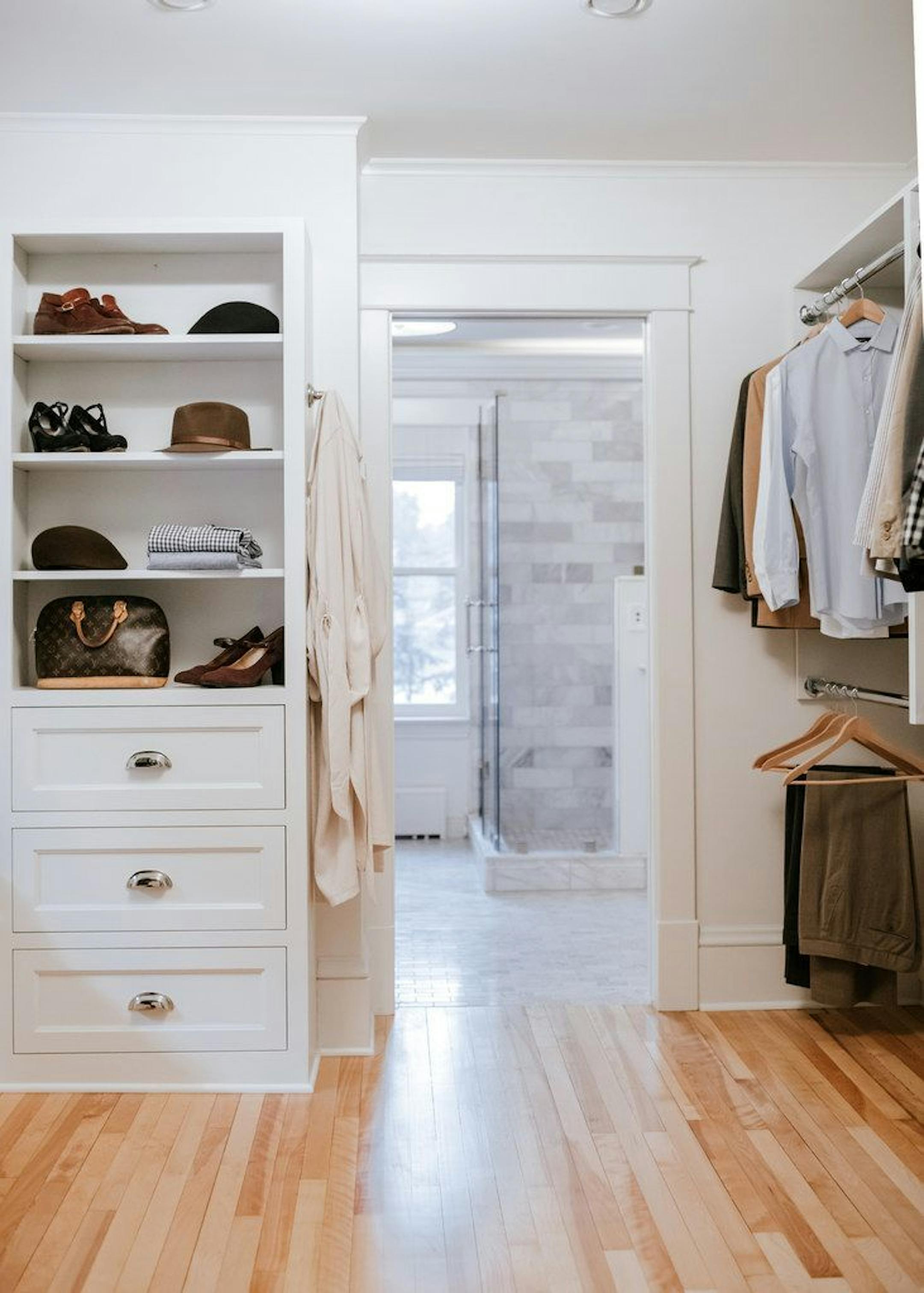 The new walk-in closet has both open and closed storage, plus a built-in bench for putting on shoes (not shown).