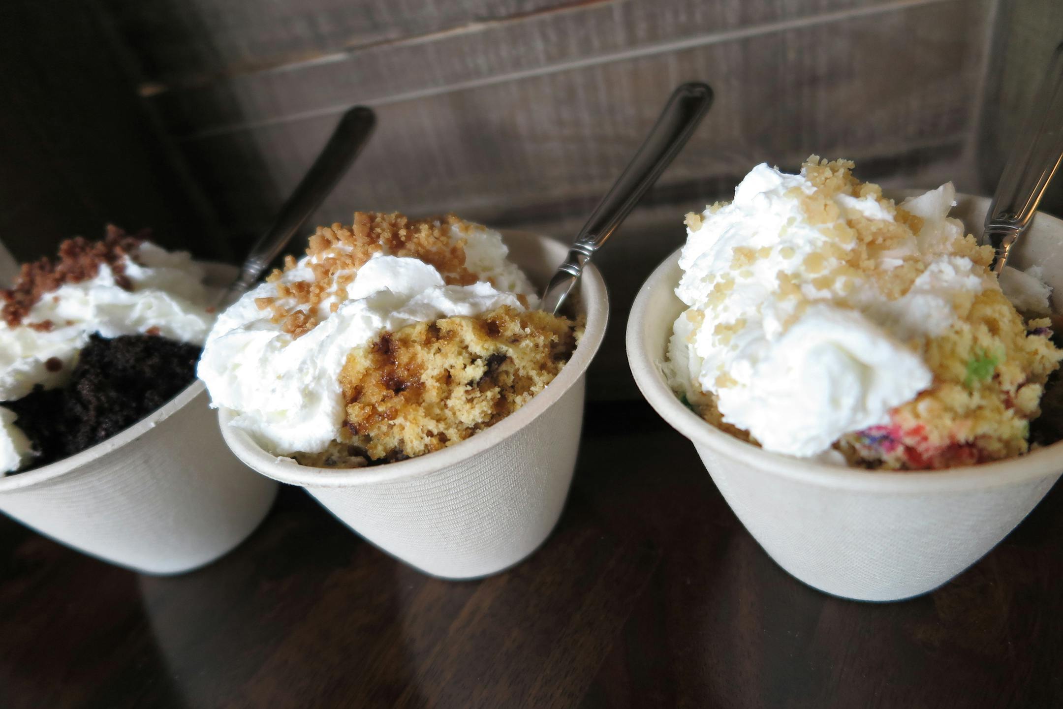 Sweetie Cakes: Choice of black forest cake, birthday cake or chocolate peanut butter cake, baked in a cup packed with Sassy Pecan toffee bits and served warm, topped with real whipping cream and more toffee bits. At Sweetie Cakes, located along the south wall of the Food Building.