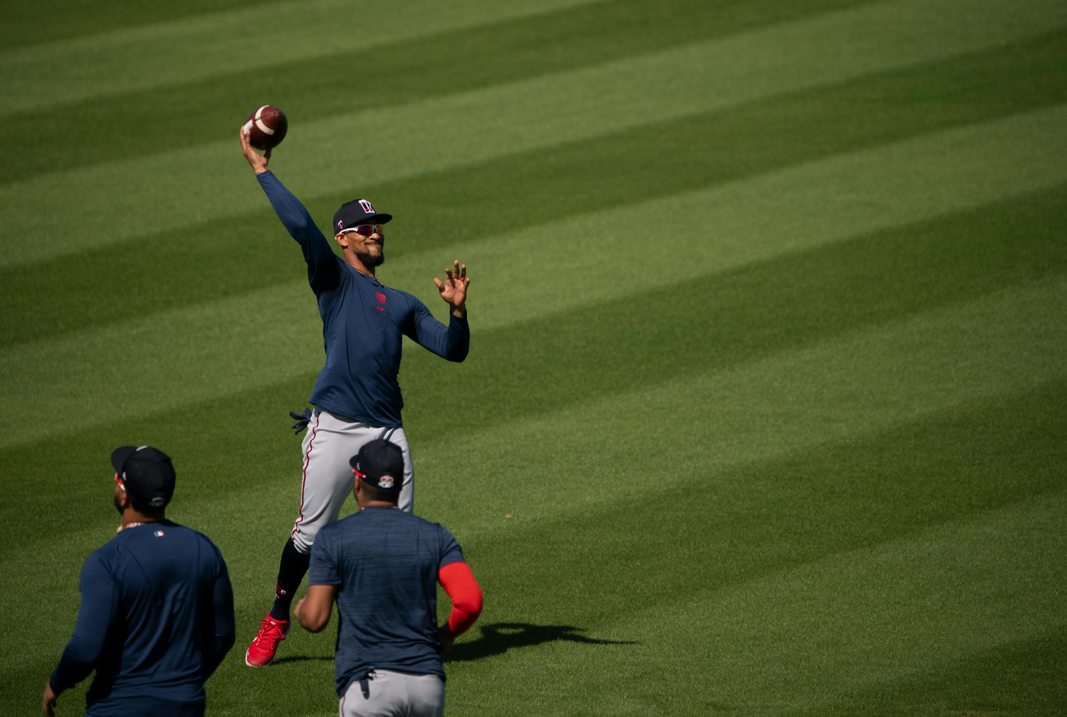 Minnesota Twins center fielder Byron Buxton tossed a football to a trainer at the beginning of the first full squad workout Tuesday morning.