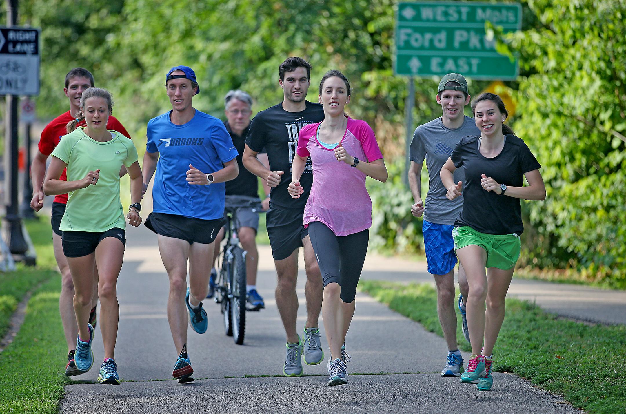 Team USA Minnesota runners from left, Eric Finan, Dani Stack, Jon Peterson, coach Dennis Barker, on bike, Travis Burkstrand, Gabriele Grunewald, Jon Grey, and Gina Valgoi ran along Ford Parkway, Thursday, August 14, 2014.