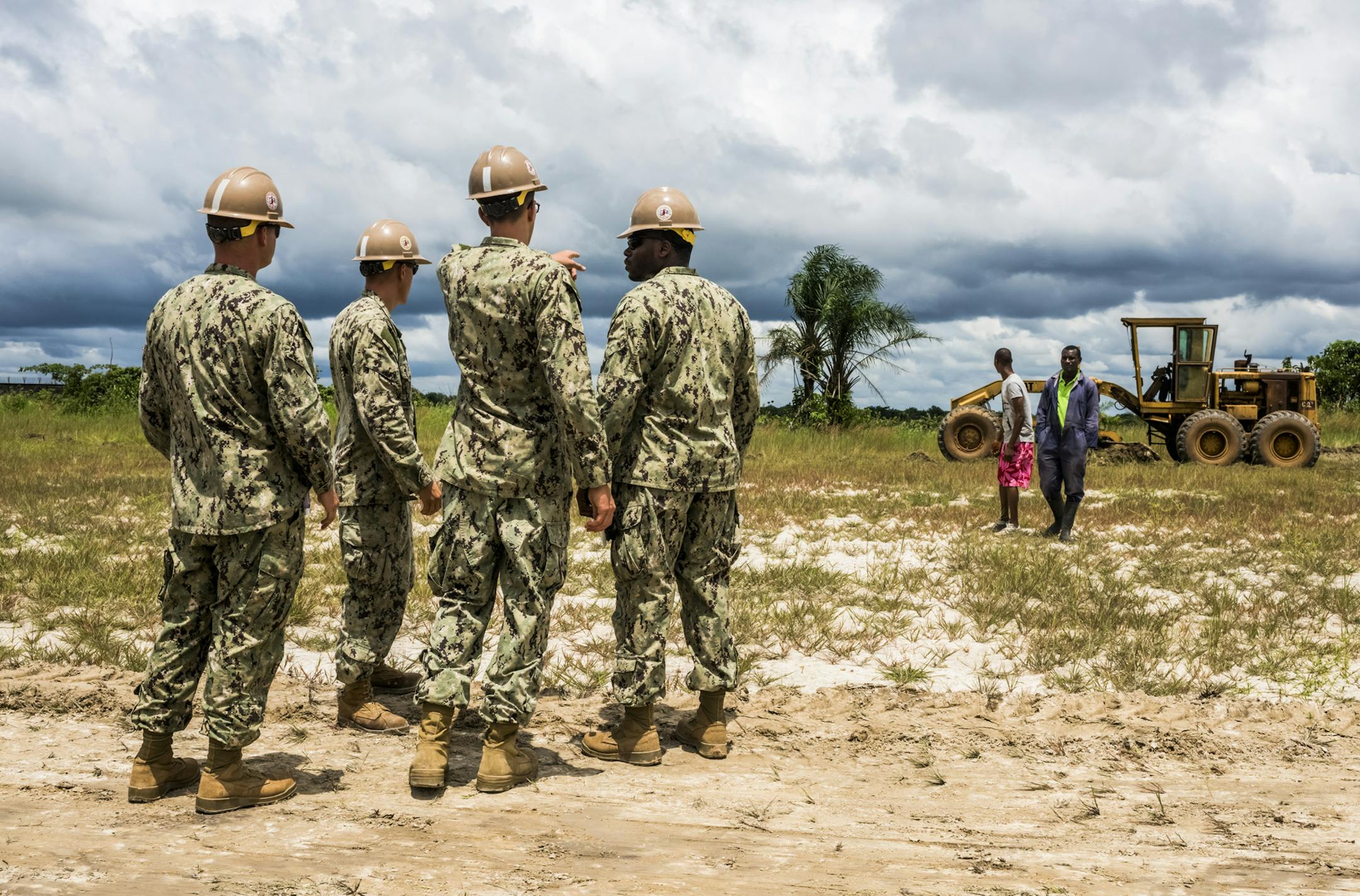 A team of U.S. Navy engineers prepares the ground for a 25-bed medical facility for Ebola patients they are building next to the Roberts International Airport in Monrovia, Liberia, Sept. 27, 2014. Two weeks after President Barack Obama announced that time was running out in the fight to stem the epidemic, the American treatment centers planned here in the center of West Africa‚Äôs Ebola crisis are still a long way off. (Daniel Berehulak/The New York Times)