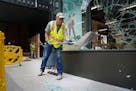 Crews worked Thursday to clean up glass and board up the broken windows at the Nordstrom Rack on Nicollet Mall.