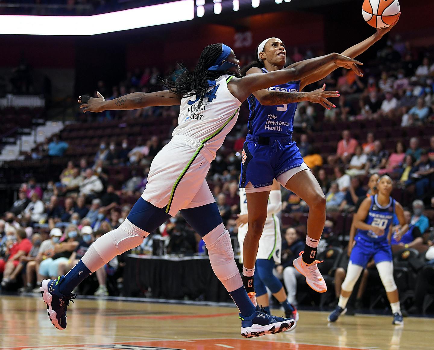 Connecticut Sun's Jasmine Thomas puts up a basket over the Lynx's Sylvia Fowles on Tuesday