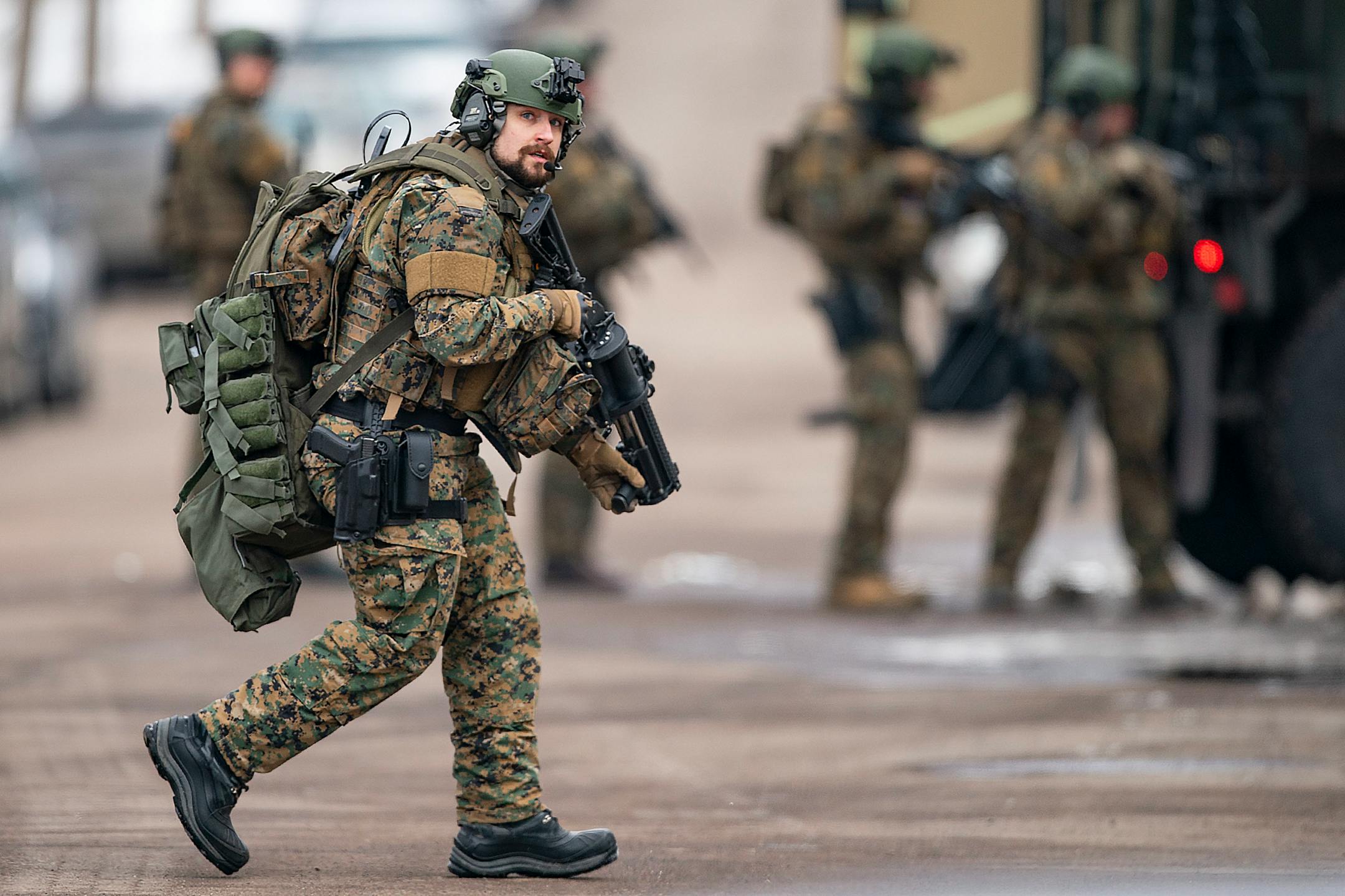 St. Louis County sheriffs were armed with rifles and grenade launchers as they maintained a perimeter and attempted to force the gunman out of his house.