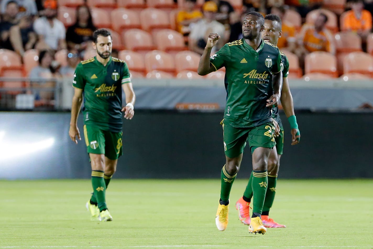 Portland Timbers' Diego Valeri, left, Dairon Asprilla, middle, and Jeremy Ebobisse, right, celebrate the goal by Asprilla during the second half of an MLS soccer match against the Houston Dynamo Wednesday, June 23, 2021, in Houston. (AP Photo/Michael Wyke)