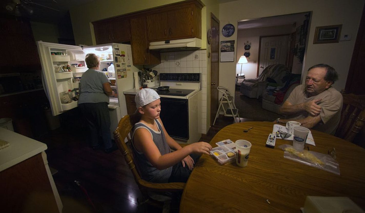 Dairy farmer Doug Steinke, 75, visited with his grandson, Tristan, 11, before beginning morning chores. At left, grandma Kathy Steinke prepared breakfast.