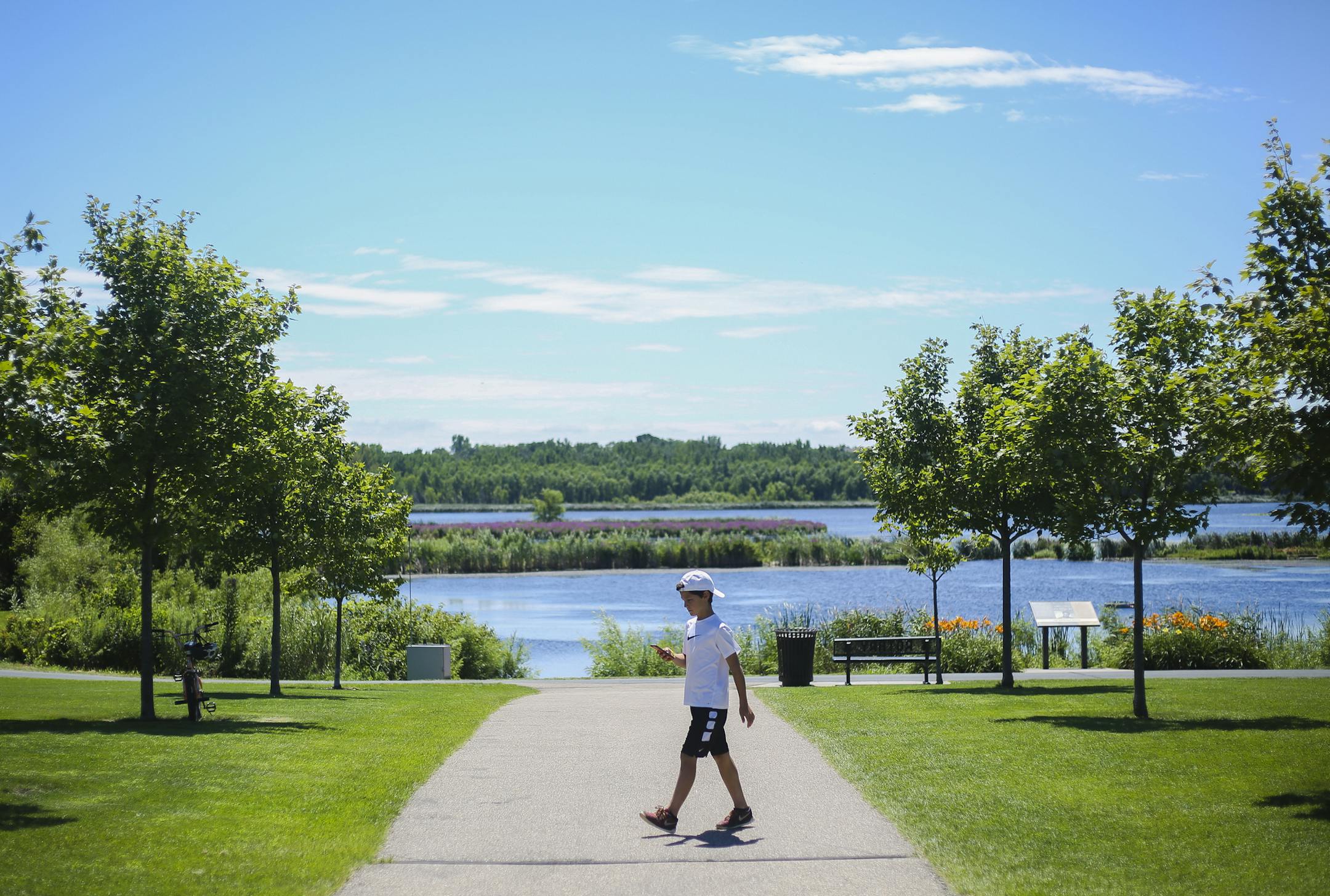 A young Pokémon Go player walks through the park in search of new Pokémon. ] Timothy Nwachukwu • timothy.nwachukwu@startribune.com Pokémon Go trainers were out in full force in search of rare, new Pokémon at Purgatory Creek Park on Friday, July 29, 2016 in Eden Prarie. Members of Eden Prarie City council contacted Pokemon Go creators, asking them to eliminate Pokestops in the city parks, especially around the Veterans Memorial due to players damaging the park's landsca