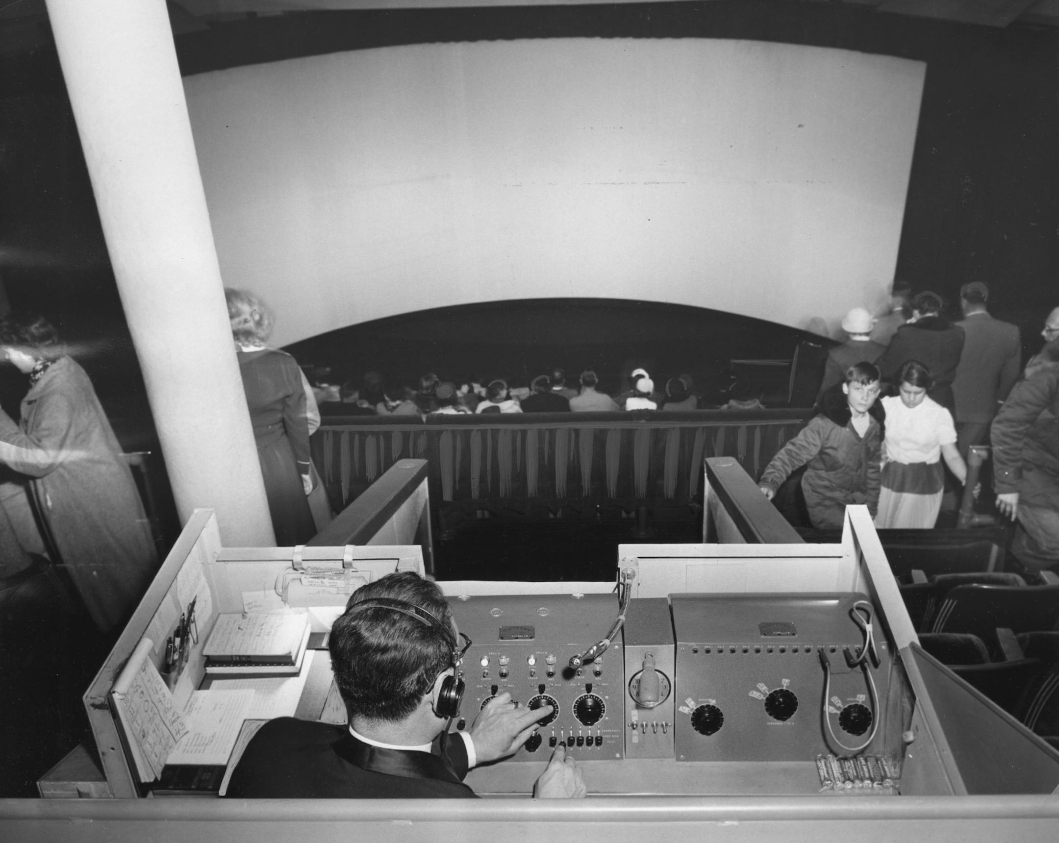 In a Cinerama presentation of a film, a console operator had to control the three projectors, audio and other elements from a balcony.