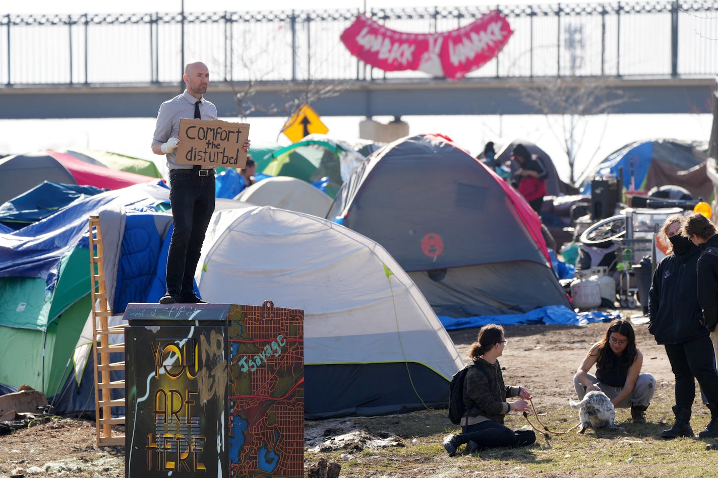 !uke (pronounced Luke) Earley stands with a sign near the East Phillips homeless encampment Tuesday, April 11, 2023 in Minneapolis. ] ANTHONY SOUFFLE • anthony.souffle@startribune.com