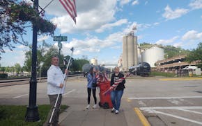 Scott and Kelly Kuehl and daughter Alexis raise the American flag in Red Wing ahead of the Memorial Day weekend.